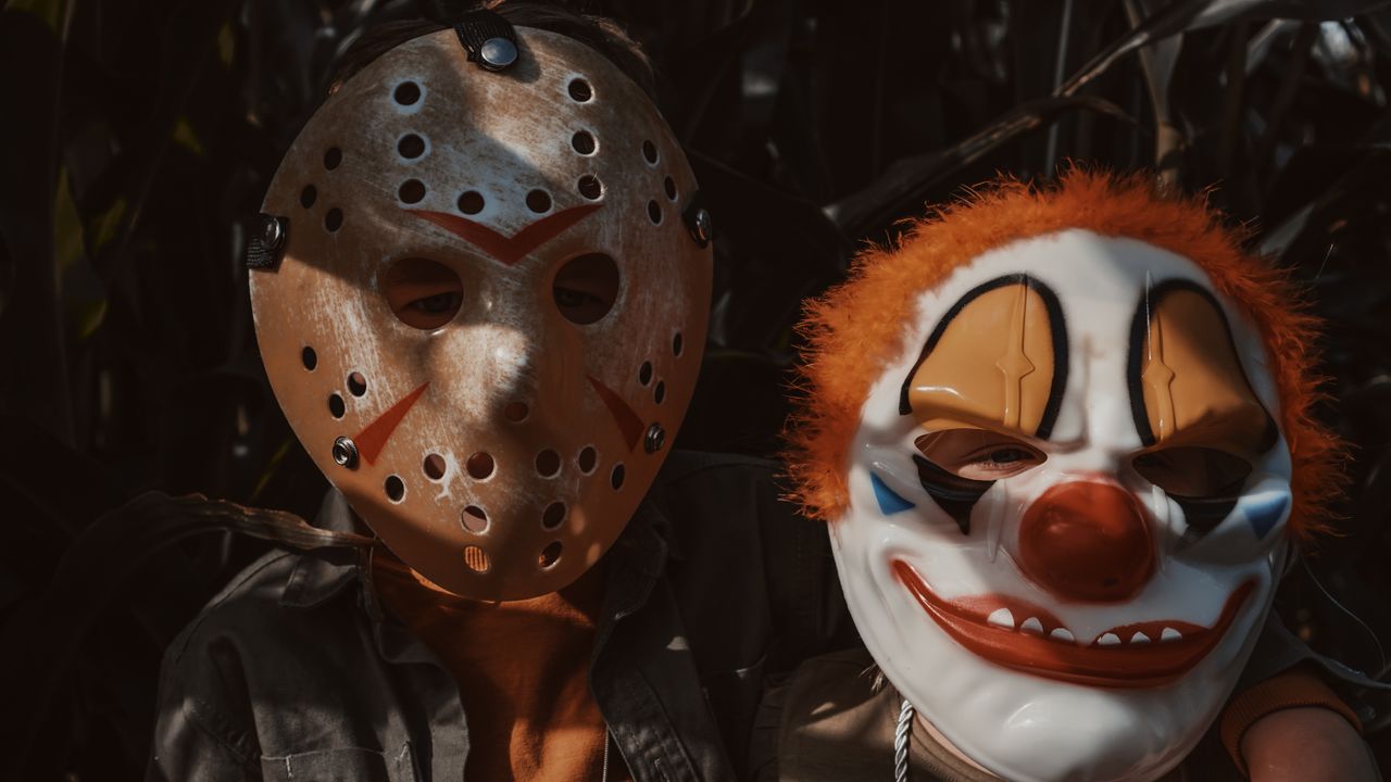 Mastering the First Impression: Your intriguing post title goes here Children wearing horror masks in a dimly lit cornfield, capturing Halloween spirit.