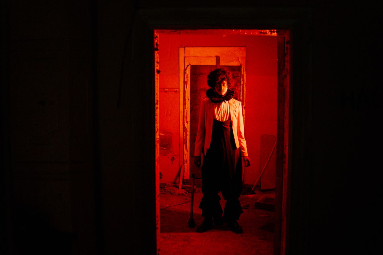 Crafting Captivating Headlines: Your awesome post title goes here Sinister clown in dim red light creates a chilling Halloween atmosphere.